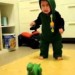 Image of Baby is scared of a dinosaur, but keeps going back for more