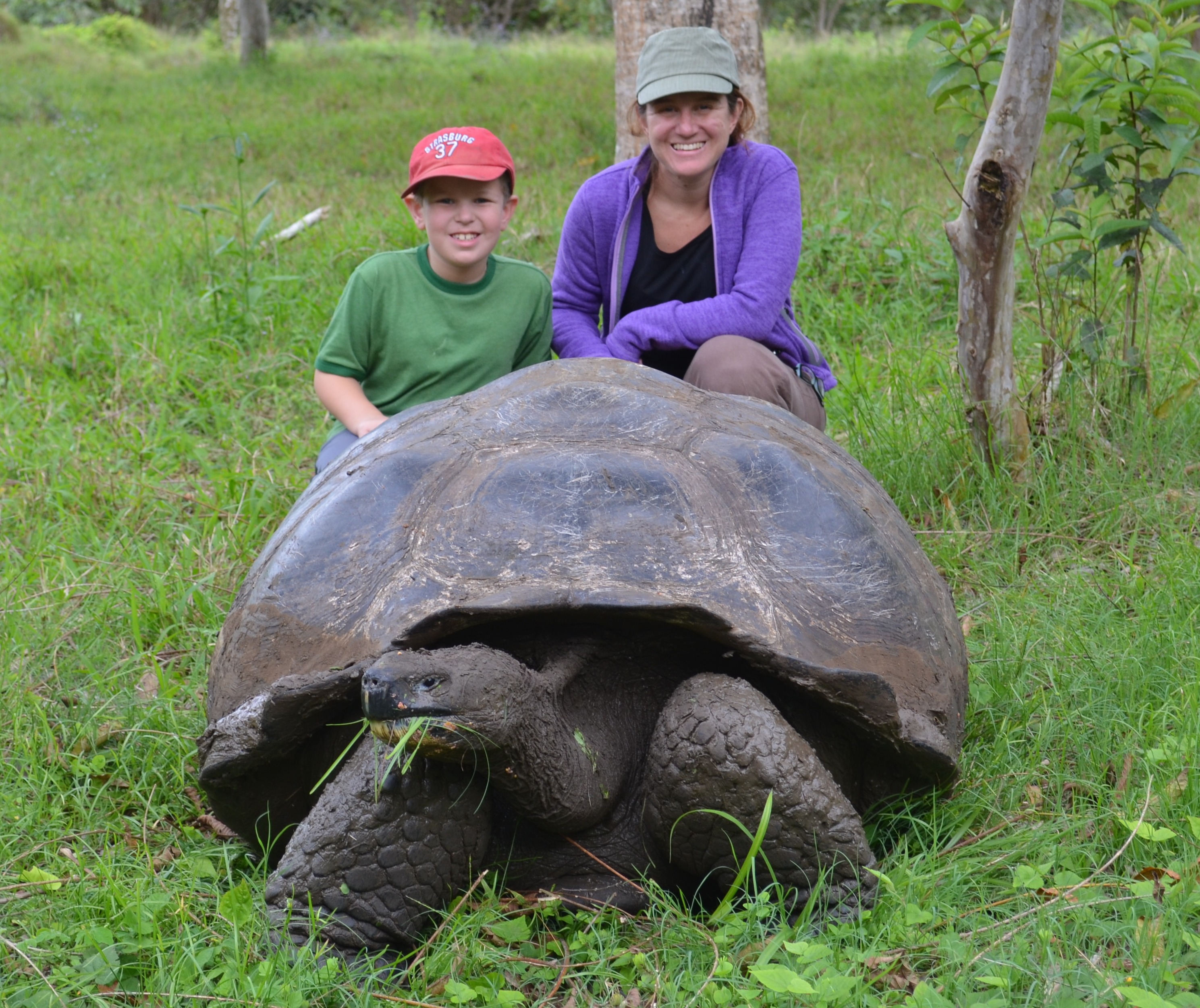 My mom and I behind a giant tortoise